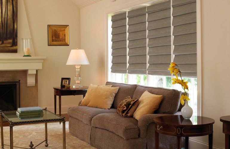 Living room with fireplace and tan Roman shades